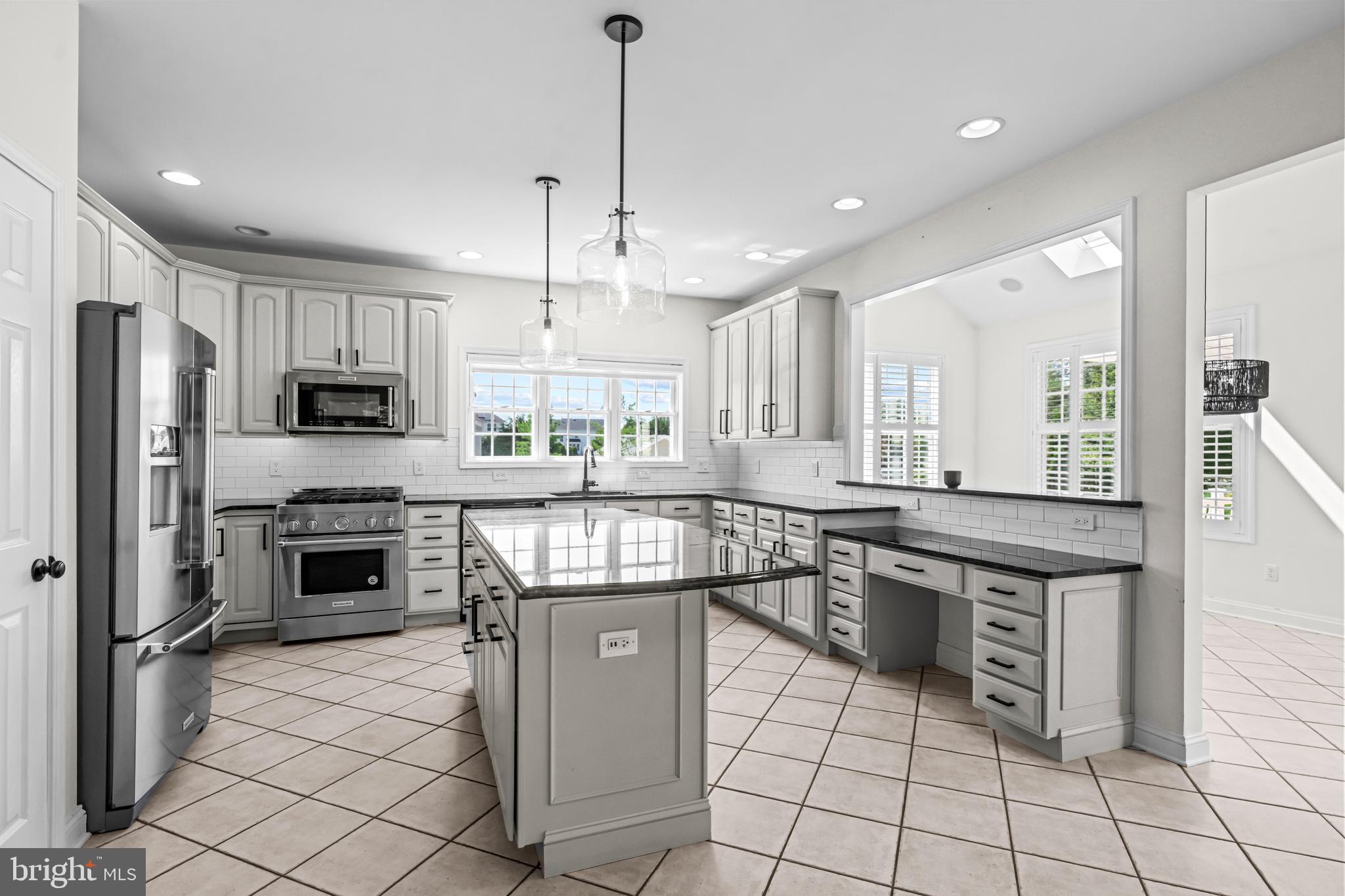 22 Tara Drive Sewell, NJ 08080 - Photo 38 of 70 a kitchen with stainless steel appliances granite countertop a stove top oven a sink a counter space and cabinets