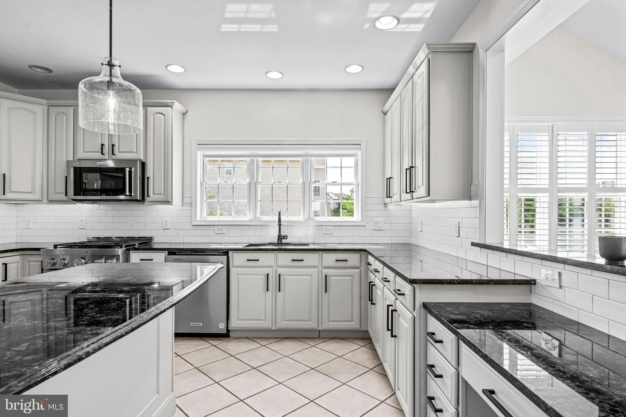 22 Tara Drive Sewell, NJ 08080 - Photo 41 of 70 a kitchen with granite countertop stainless steel appliances a sink cabinets and a window