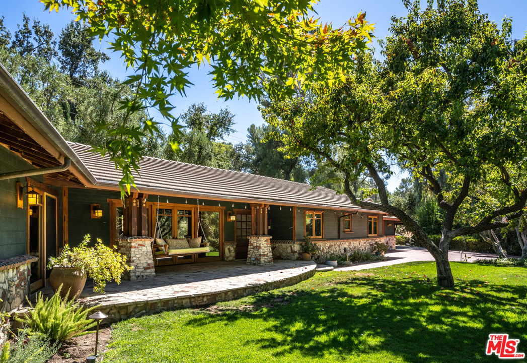 24878 Long Valley Road Hidden Hills, CA 91302 - Photo 1 of 54 a front view of a house with a yard