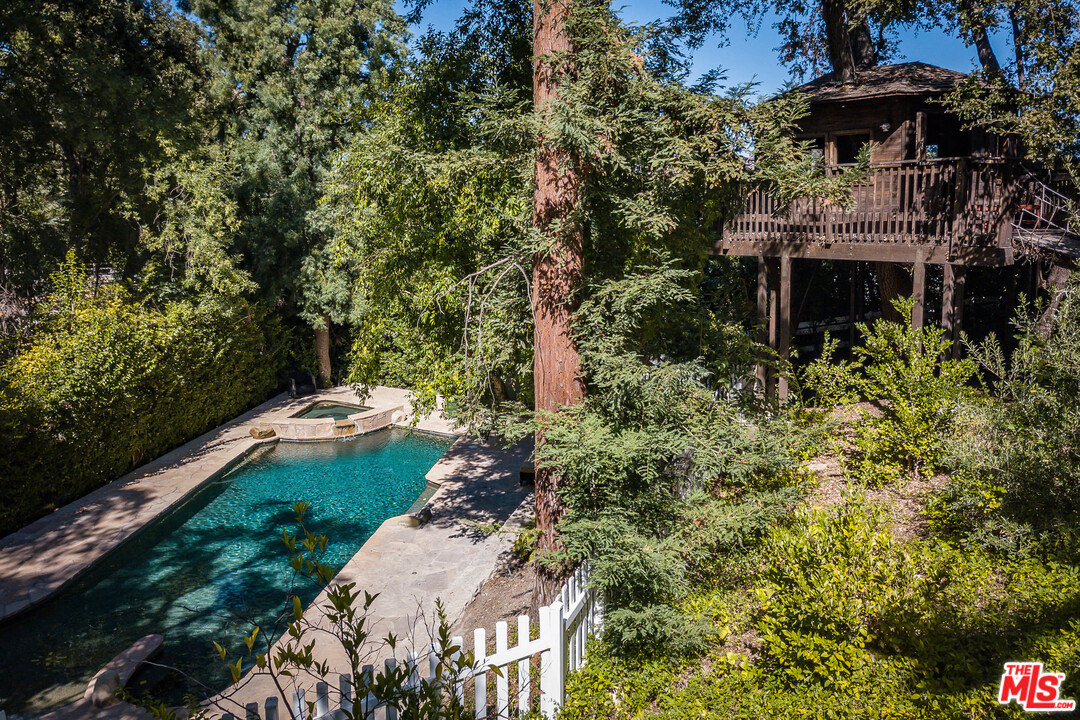 24878 Long Valley Road Hidden Hills, CA 91302 - Photo 11 of 54 a view of a chairs and table in the backyard