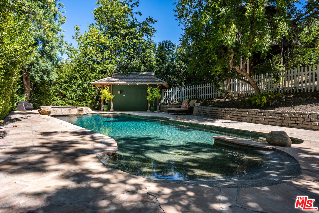 24878 Long Valley Road Hidden Hills, CA 91302 - Photo 13 of 54 a backyard of a house with barbeque oven a table and chairs