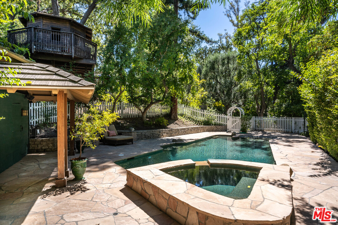 24878 Long Valley Road Hidden Hills, CA 91302 - Photo 16 of 54 a view of backyard with swimming pool and outdoor seating