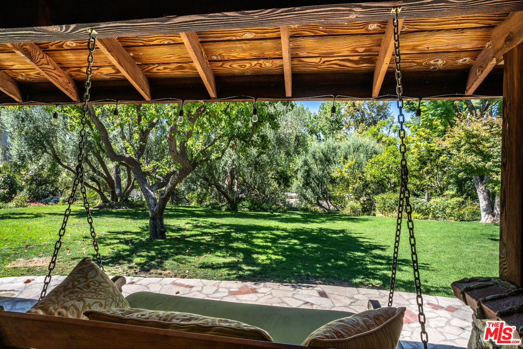 24878 Long Valley Road Hidden Hills, CA 91302 - Photo 27 of 54 a backyard of a house with a yard and outdoor seating