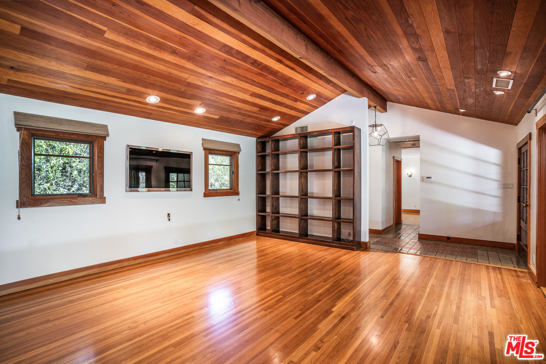 24878 Long Valley Road Hidden Hills, CA 91302 - Photo 32 of 54 a view of an empty room with wooden floor and windows