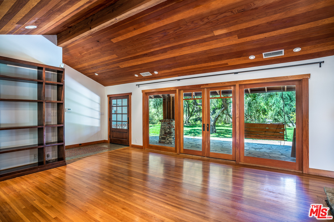 24878 Long Valley Road Hidden Hills, CA 91302 - Photo 33 of 54 a view of an empty room with wooden floor and a window