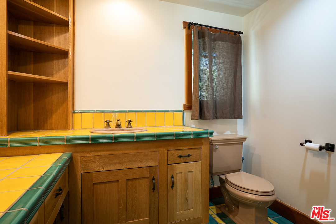 24878 Long Valley Road Hidden Hills, CA 91302 - Photo 34 of 54 a bathroom with a sink and a toilet