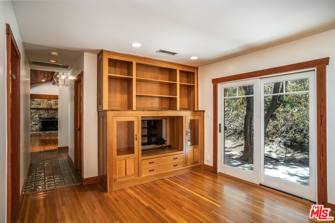 24878 Long Valley Road Hidden Hills, CA 91302 - Photo 35 of 54 a view of an empty room with wooden floor and a window