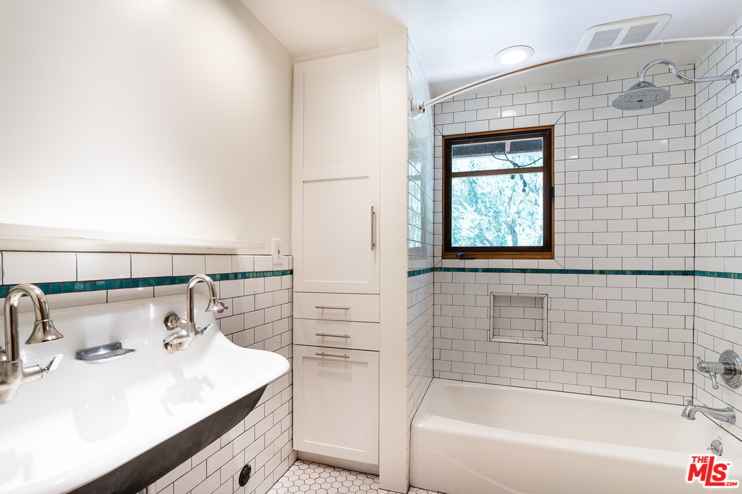 24878 Long Valley Road Hidden Hills, CA 91302 - Photo 37 of 54 a bathroom with a sink and a bathtub