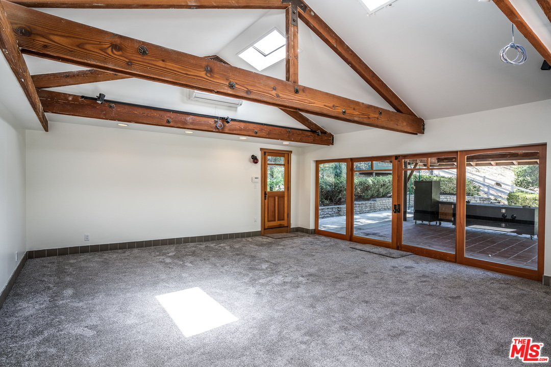 24878 Long Valley Road Hidden Hills, CA 91302 - Photo 42 of 54 a view of an empty room with a balcony