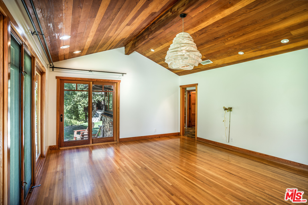 24878 Long Valley Road Hidden Hills, CA 91302 - Photo 44 of 54 a view of an empty room with wooden floor and a window