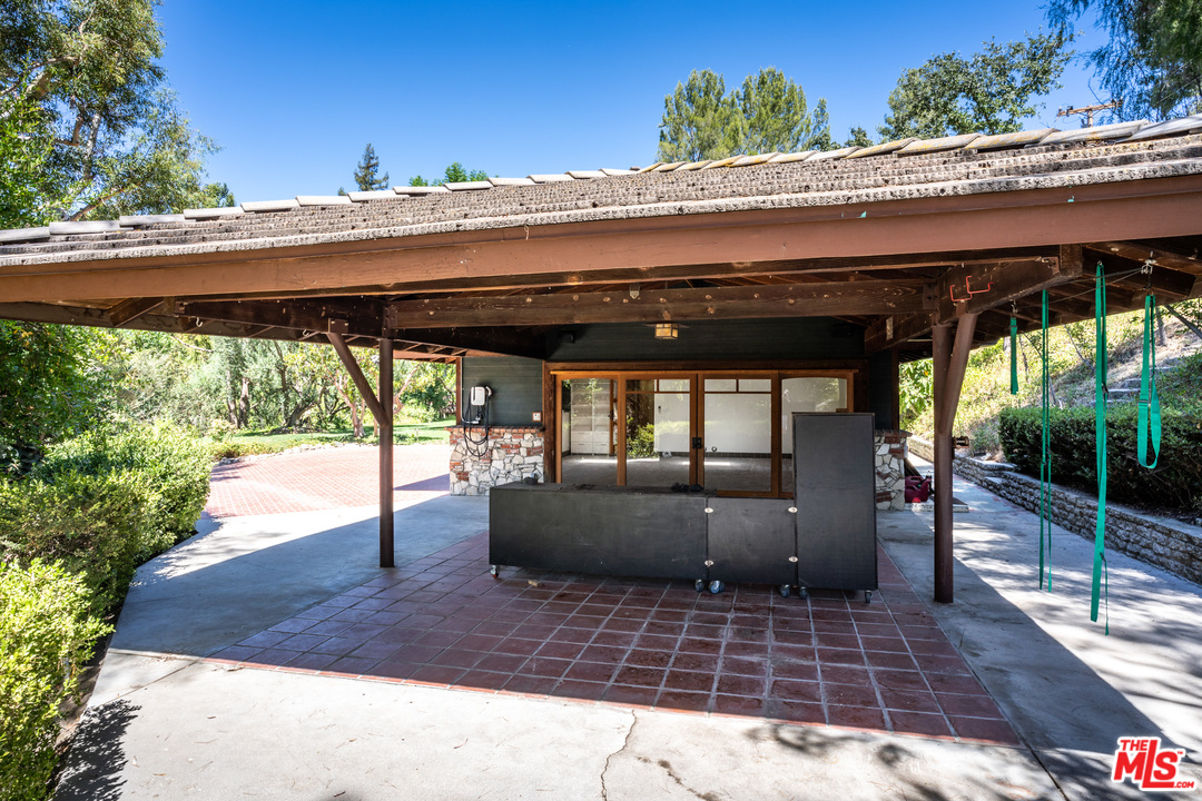 24878 Long Valley Road Hidden Hills, CA 91302 - Photo 50 of 54 a view of a porch with a table and chairs