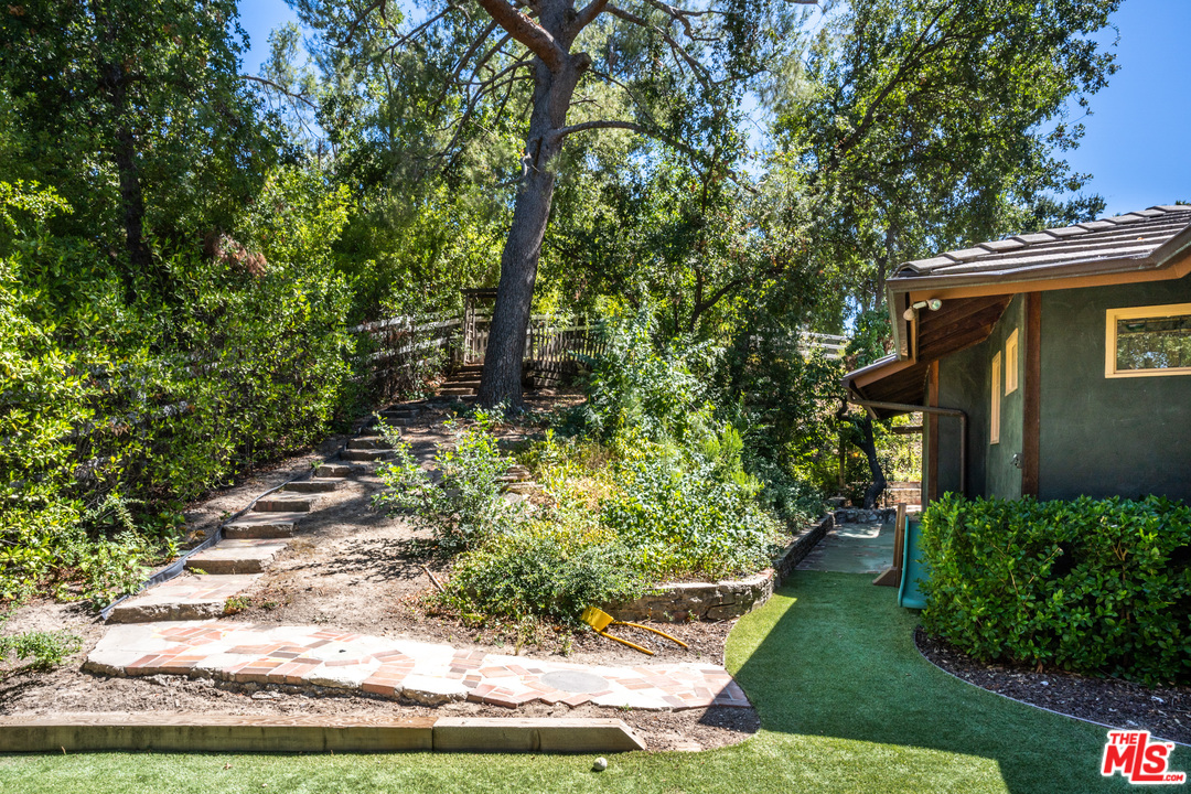 24878 Long Valley Road Hidden Hills, CA 91302 - Photo 54 of 54 a front view of a house with a yard