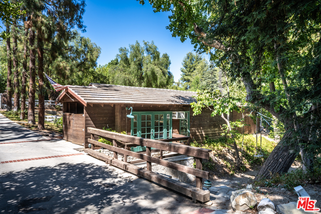24878 Long Valley Road Hidden Hills, CA 91302 - Photo 8 of 54 a view of a patio with table and chairs under an umbrella