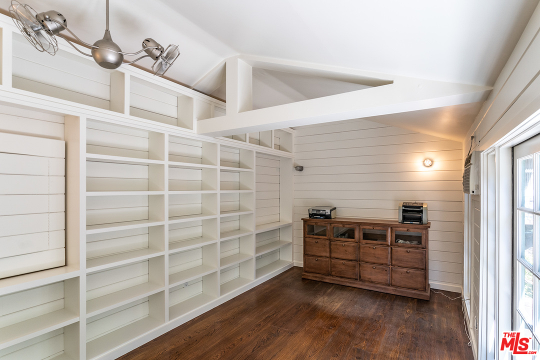 24878 Long Valley Road Hidden Hills, CA 91302 - Photo 9 of 54 a view of an empty room with wooden floor and a window