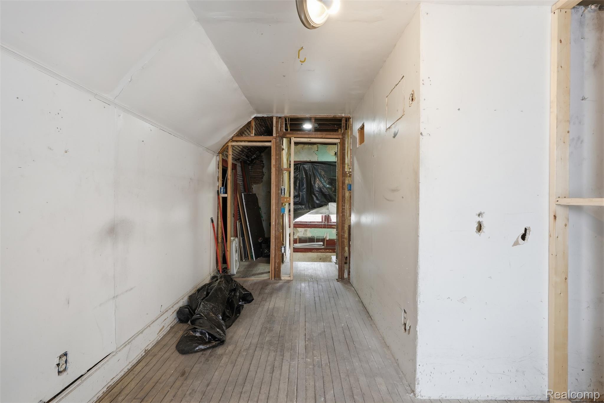 2500 Atkinson Street Detroit, MI 48206 - Photo 15 of 21 Hallway with vaulted ceiling and light wood-type flooring
