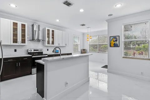 a kitchen with stainless steel appliances granite countertop a sink stove and cabinets
