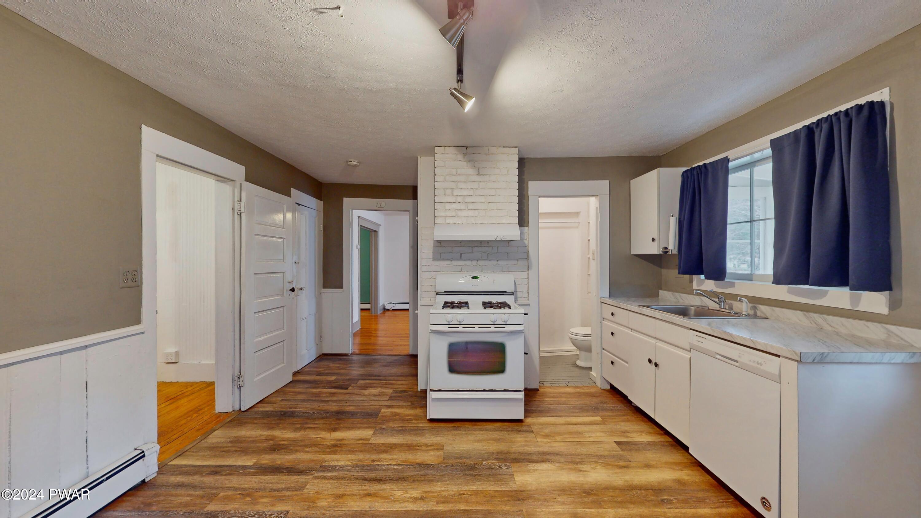 108 9th Street Milford, PA 18337 - Photo 9 of 38 a kitchen with stainless steel appliances granite countertop a stove a sink and a refrigerator