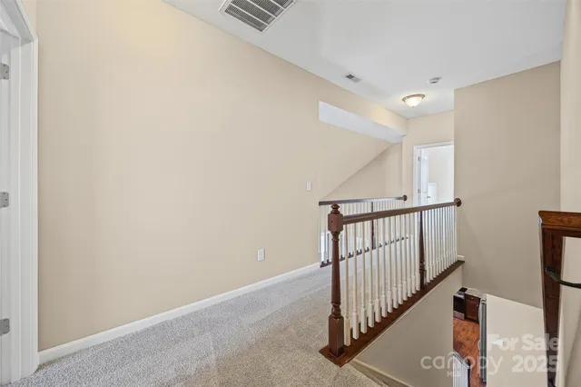 a view of a hallway with stairs
