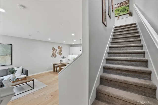 a living room with furniture and stairs