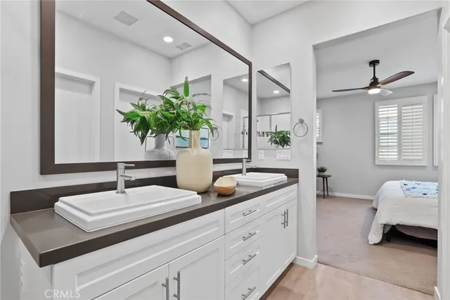 a en suite bathroom with double sink and a mirror
