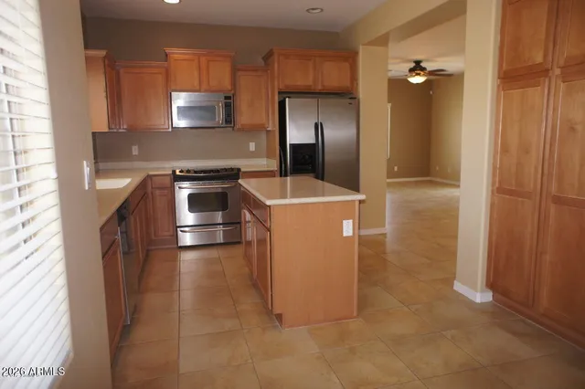 a kitchen with a stove a refrigerator and a sink