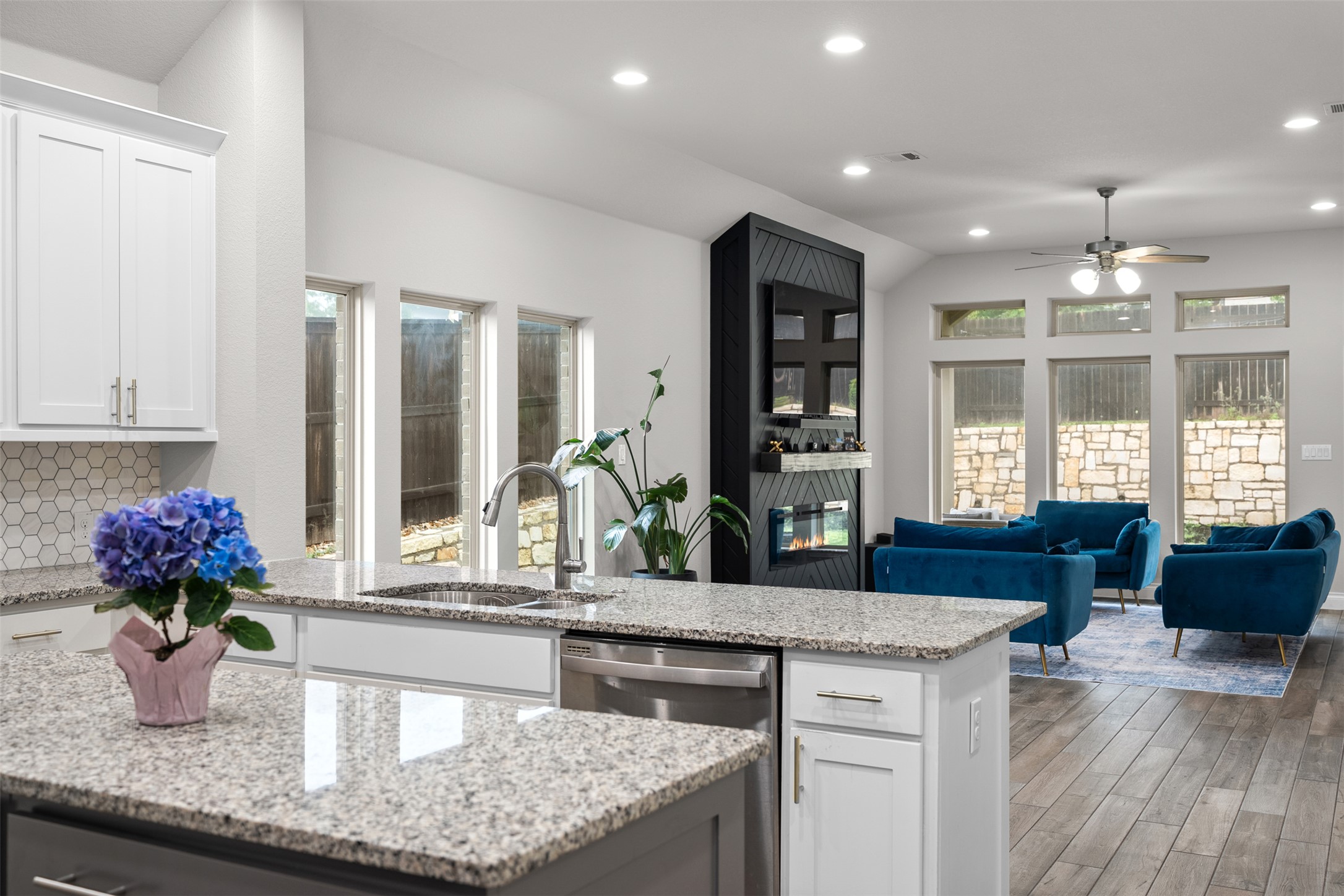 341 Pisa Lane Georgetown, TX 78628 - Photo 13 of 31 a kitchen with stainless steel appliances granite countertop a sink dishwasher with a dining table and chairs