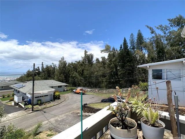 a view of a patio with table and chairs potted plants