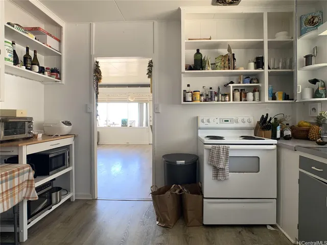 a kitchen with a refrigerator and a stove