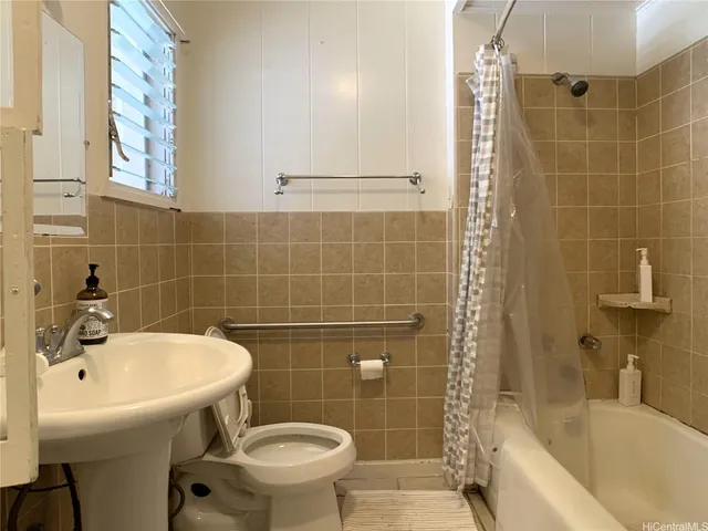 a bathroom with a sink a toilet and bathtub