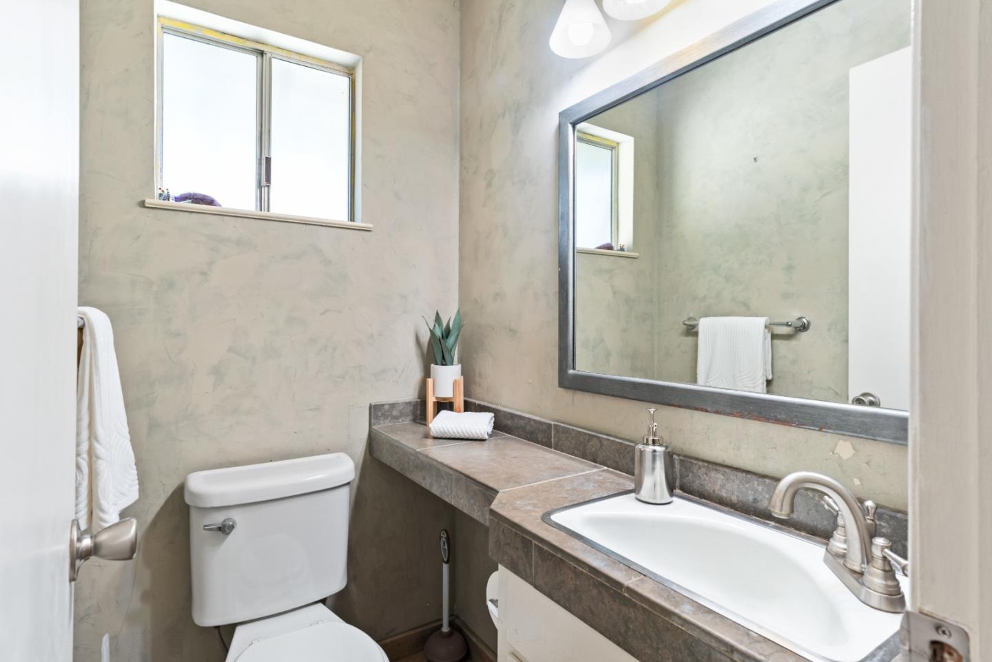 1850 Pine Flat Road Santa Cruz, CA 95060 - Photo 32 of 62 a bathroom with a granite countertop toilet sink and mirror