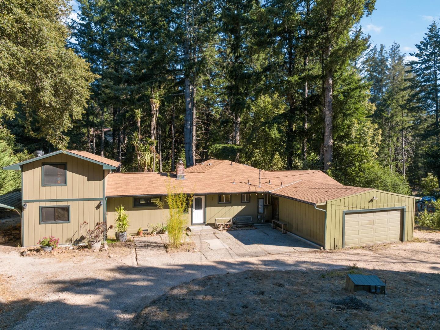 1850 Pine Flat Road Santa Cruz, CA 95060 - Photo 39 of 62 a patio with a table and chairs under an umbrella