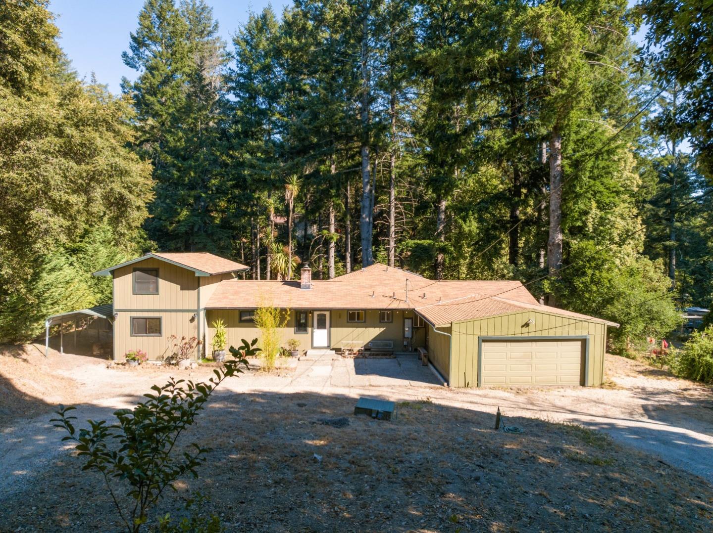 1850 Pine Flat Road Santa Cruz, CA 95060 - Photo 40 of 62 a view of a white house with a yard plants and large tree