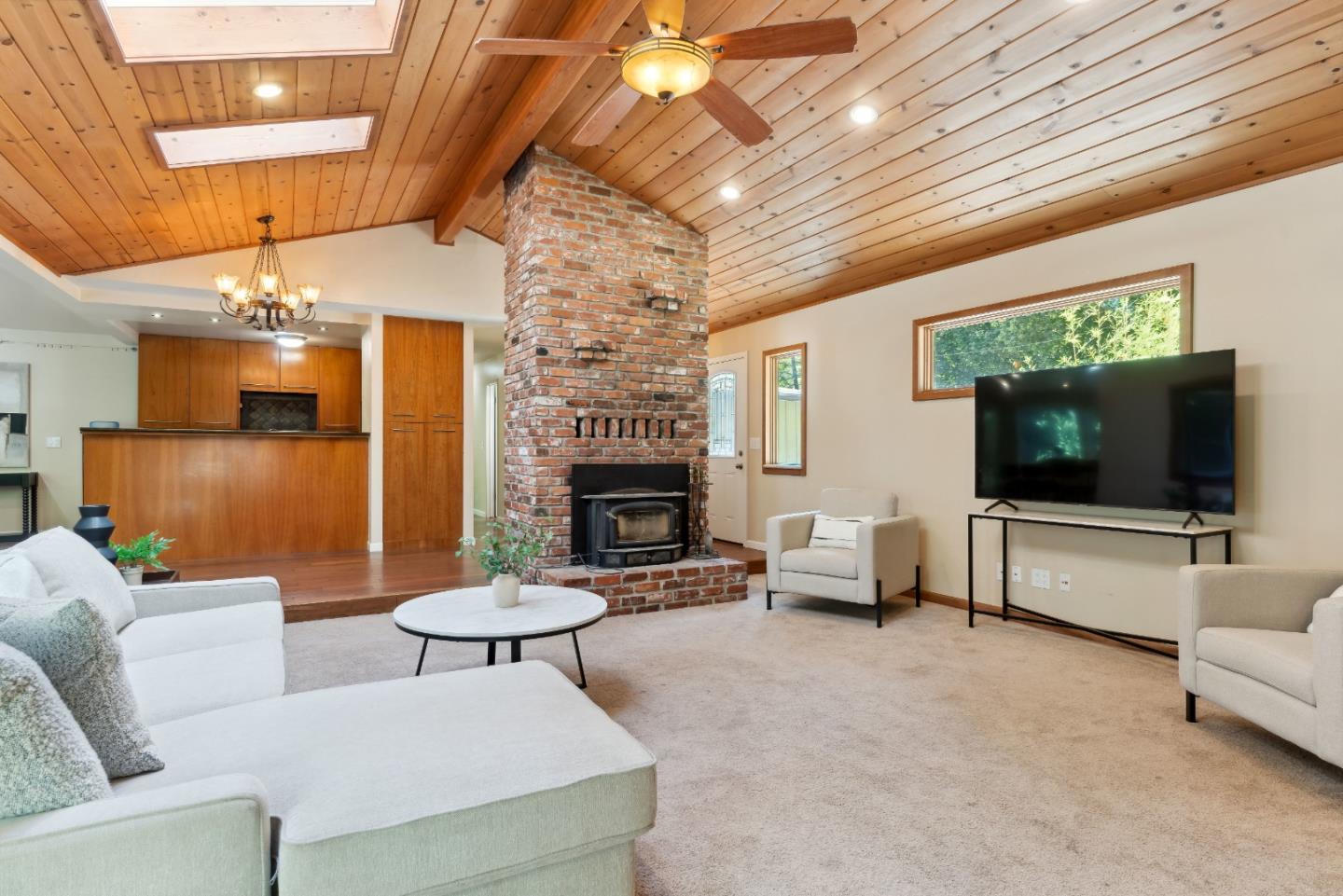 1850 Pine Flat Road Santa Cruz, CA 95060 - Photo 5 of 62 a living room with furniture a flat screen tv and a fireplace