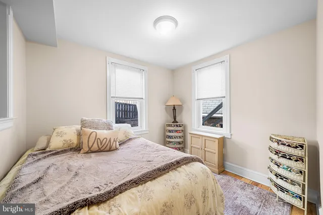 a bedroom with a bed and a desk