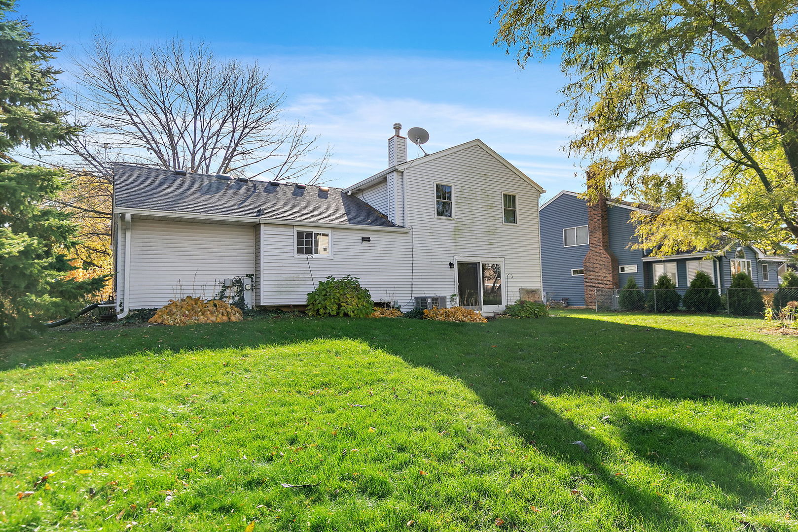 517 Sheffield Road Naperville, IL 60565 - Photo 21 of 29 a view of a yard in front of a house with plants and large tree