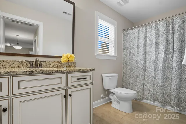 a view of a backyard with a garden and entertaining space