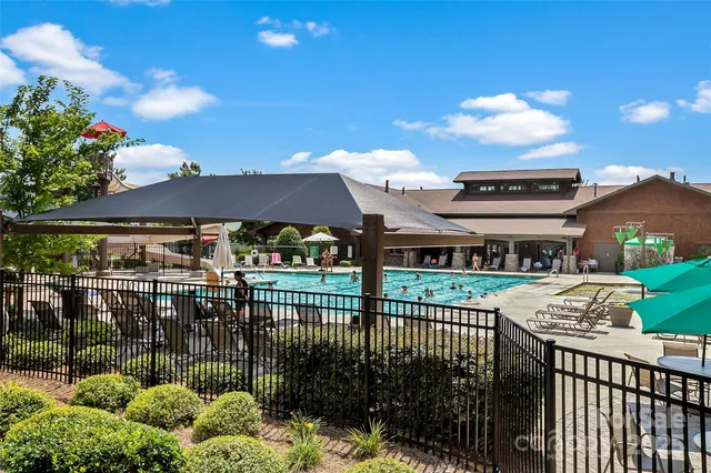 a view of a tennis ground with large trees