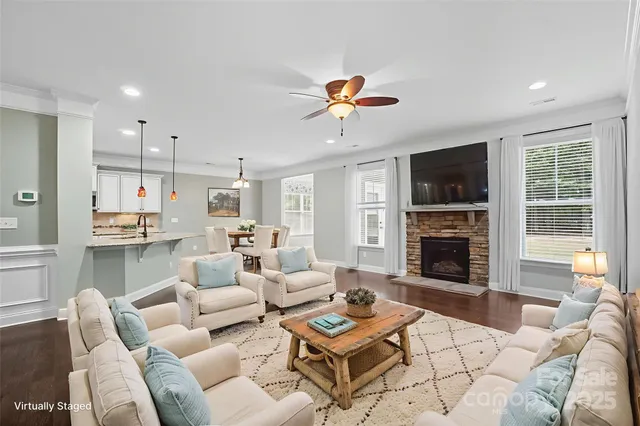 a view of empty room with wooden floor and fireplace