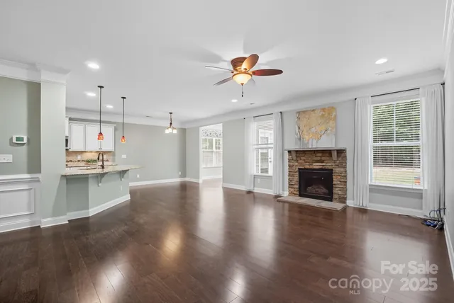 a view of a kitchen with a sink and wooden floor