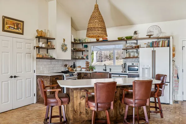 a dining table with chairs and wooden floor