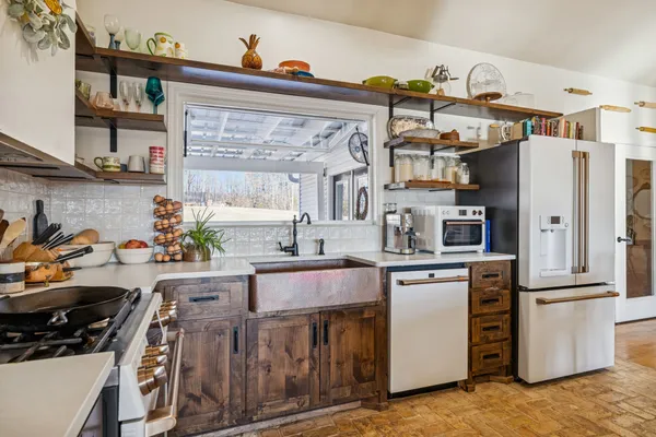 a kitchen with stainless steel appliances granite countertop a refrigerator and a stove