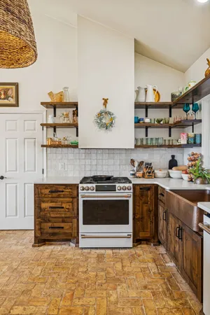 a kitchen with stainless steel appliances granite countertop a stove and a sink