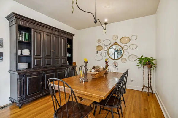 a view of a dining room with furniture and wooden floor