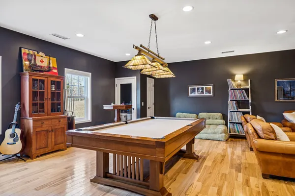a living room with furniture a flat screen tv and a chandelier