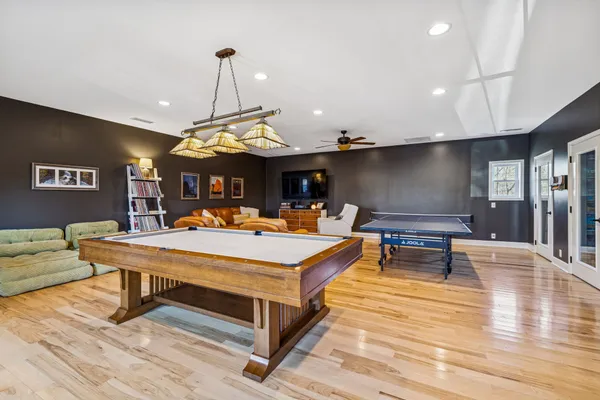 a living room with furniture a table and kitchen view