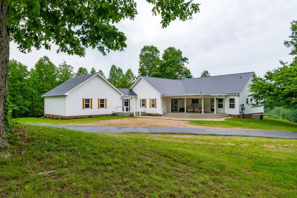a front view of a house with a big yard