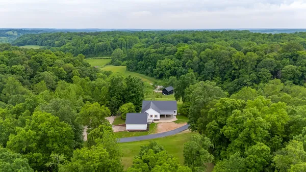 a view of a house with a yard and garden