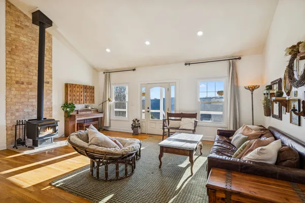 a living room with furniture a rug and a floor to ceiling window