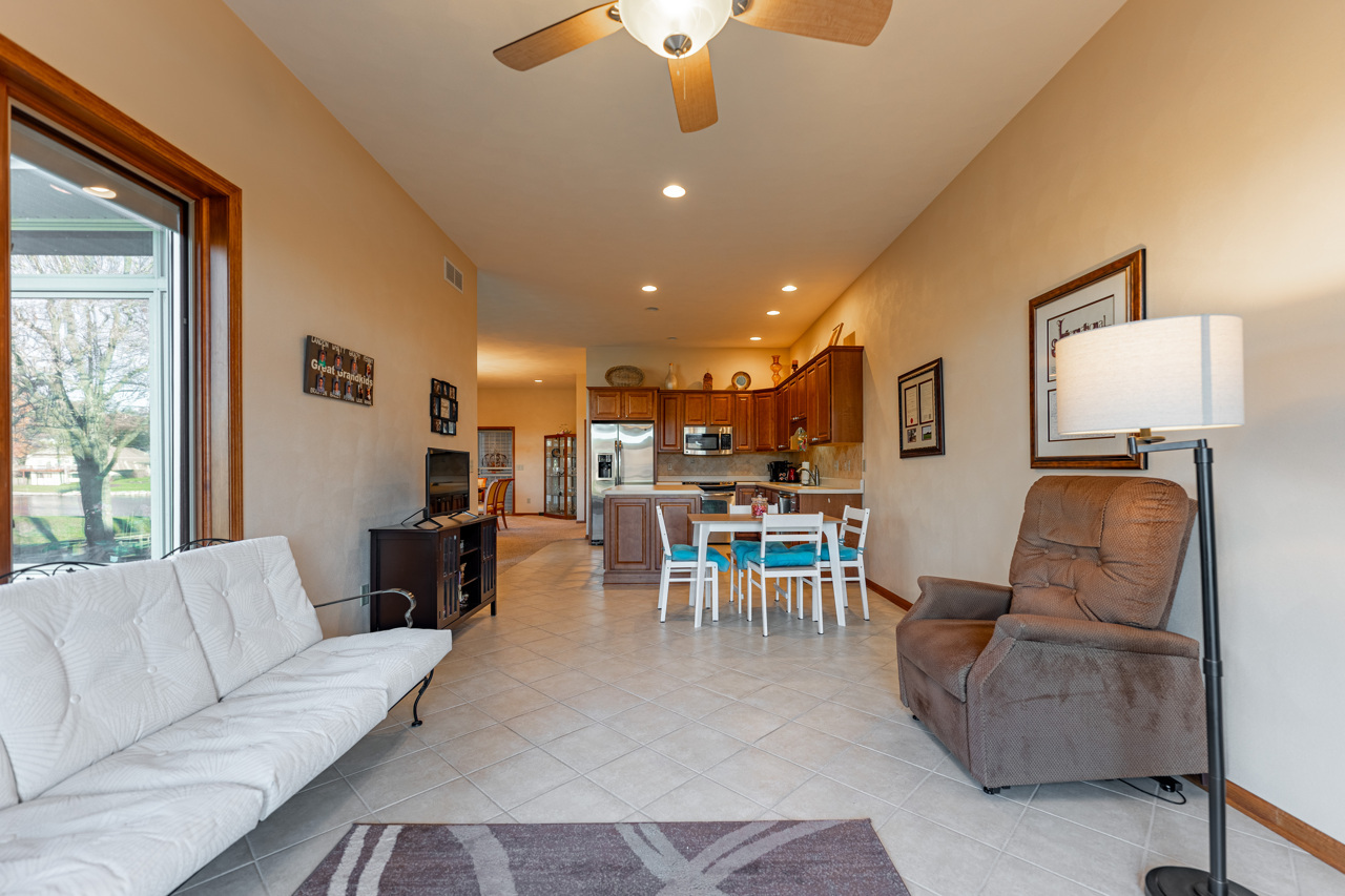 5624 Spring Brook Road, Unit 5624 Rockford, IL 61114 - Photo 12 of 34 a living room with furniture and a chandelier