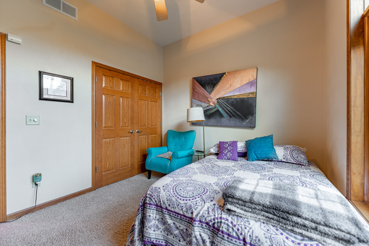 5624 Spring Brook Road, Unit 5624 Rockford, IL 61114 - Photo 20 of 34 a bedroom with a bed and a painting on the wall